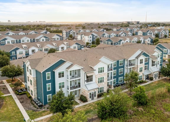 an aerial view of a row of townhomes with trees in the foreground
