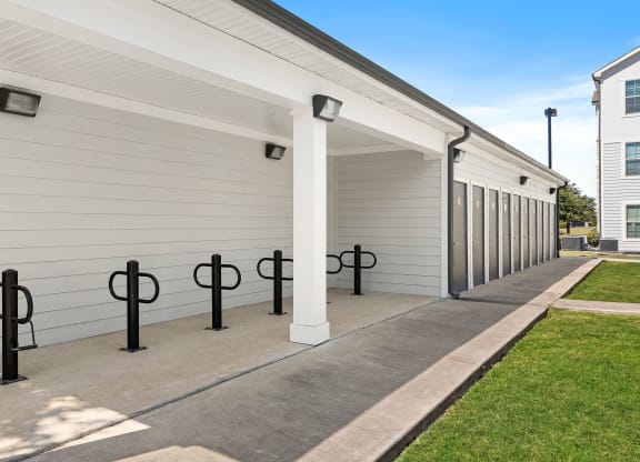 a row of garage doors at the whispering winds apartments in pearland, tx