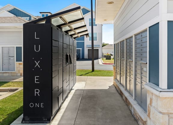 a package locker next to a building at bexley at tech ridge.