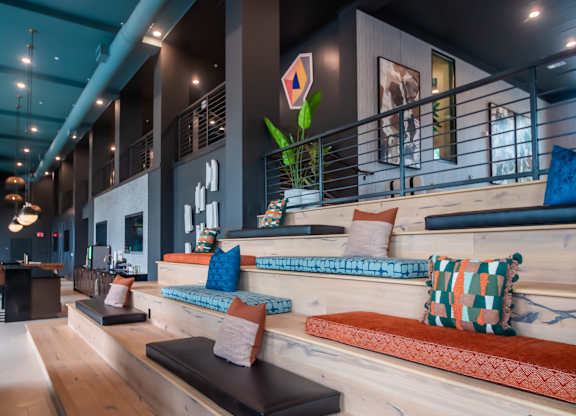 a seating area with pillows and cushions in a lobby