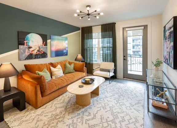 a living room with a orange couch and a coffee table