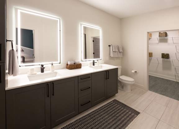 a bathroom with two sinks and a shower and a toilet