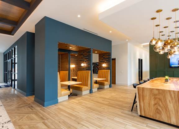 a large lobby with a table and chairs and a reception desk