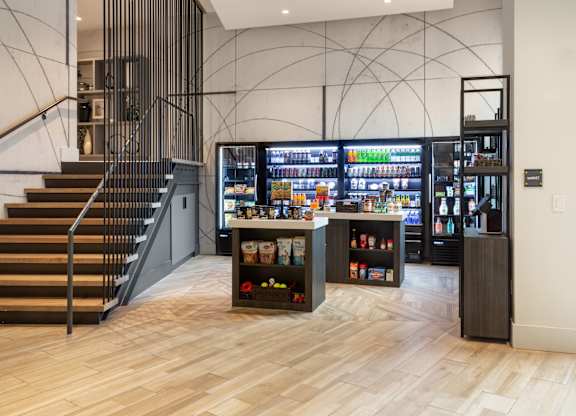 the lobby of a store with a vending machine and stairs