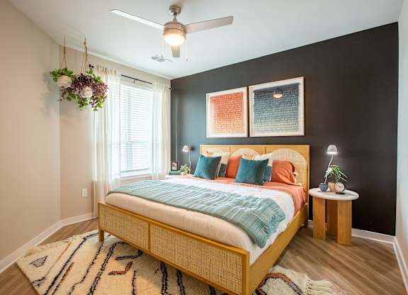 a bedroom with a bed and a ceiling fan