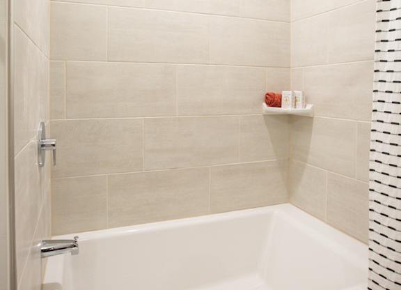 a white bath tub in a bathroom with a shower curtain