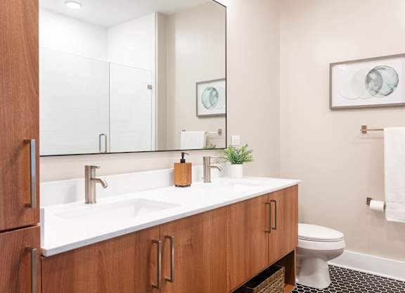 a bathroom with a sink and a toilet and a mirror