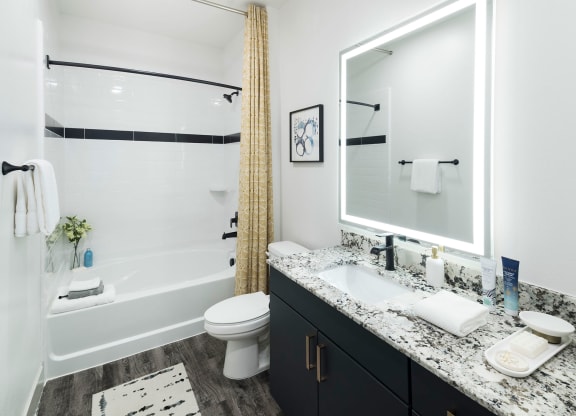 a bathroom with a shower and a sink and a toilet