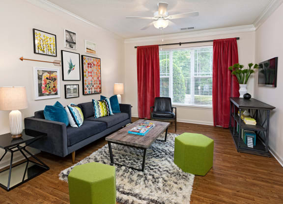 A living room with a blue couch, a coffee table, and a rug.