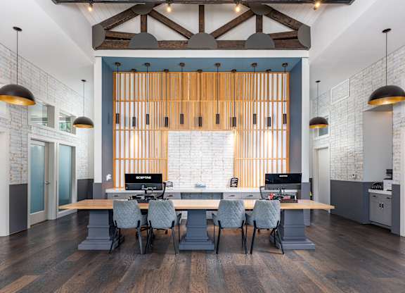 A modern office space with a long table and chairs.