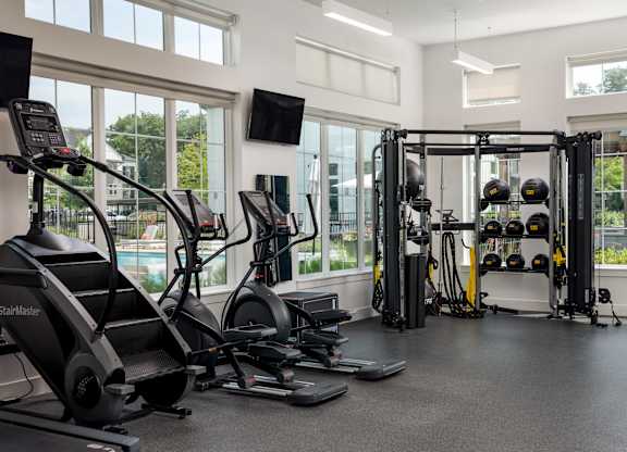 A gym with treadmills, weights, and exercise equipment.