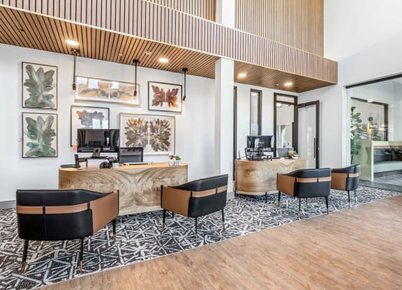a lobby with a desk and chairs and a reception area