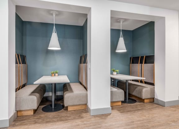 a dining room with tables and chairs and blue walls
