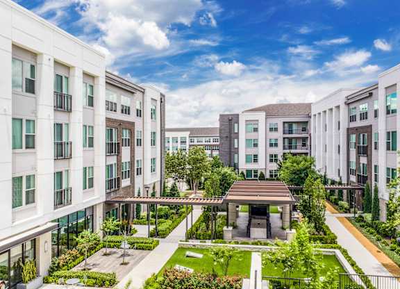 A modern apartment complex with a courtyard garden.