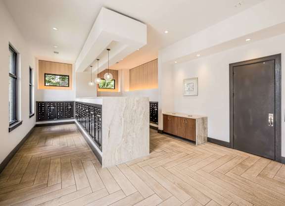 A modern interior with a wooden floor and a black door.