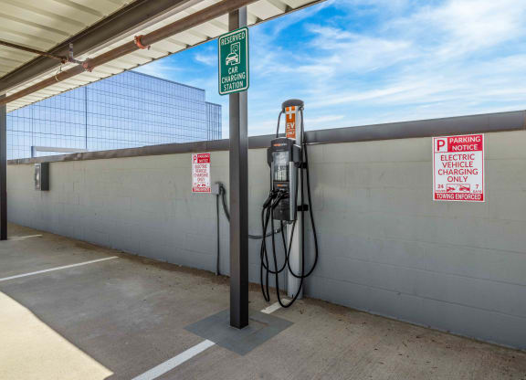 an electric vehicle charging in a parking garage