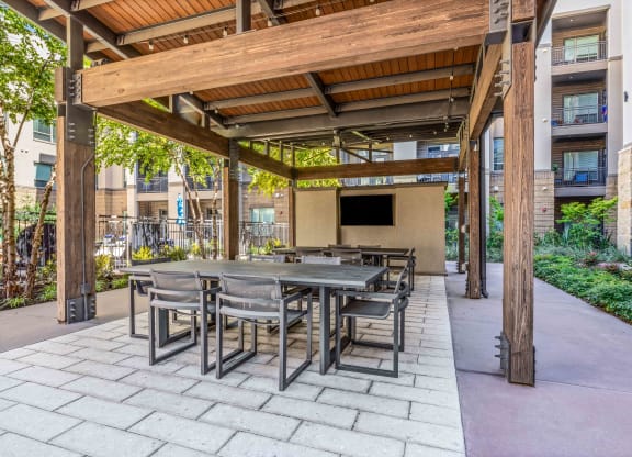 large patio with a pergola and tables and chairs