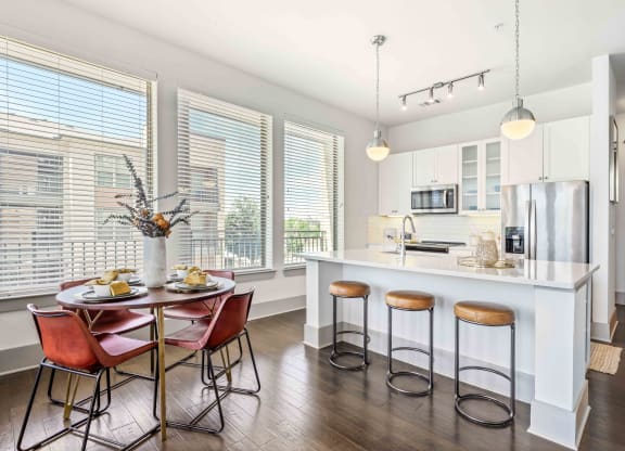 a kitchen with a large island with a breakfast bar and stools