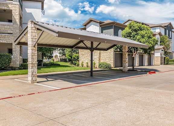 A covered walkway leads to a row of houses.