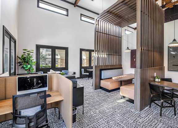 A modern office space with wooden slats on the wall and a variety of seating options.