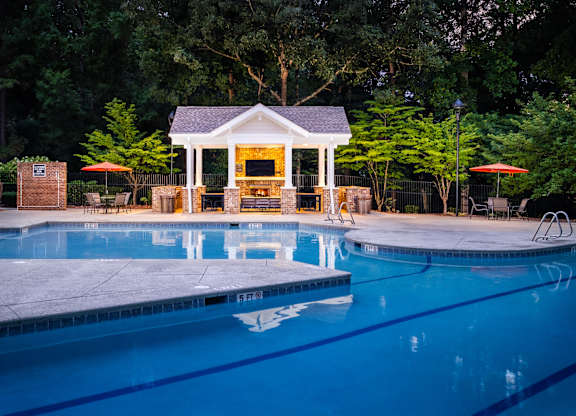 A pool with a gazebo in the background.