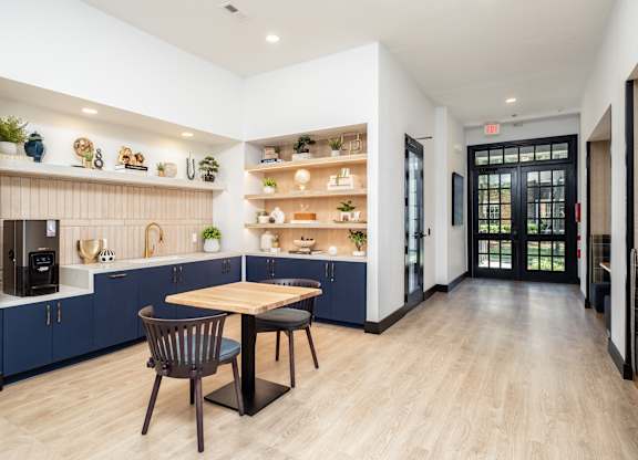 A modern kitchen with a dining table and chairs.