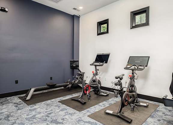 A room with exercise bikes and a window.