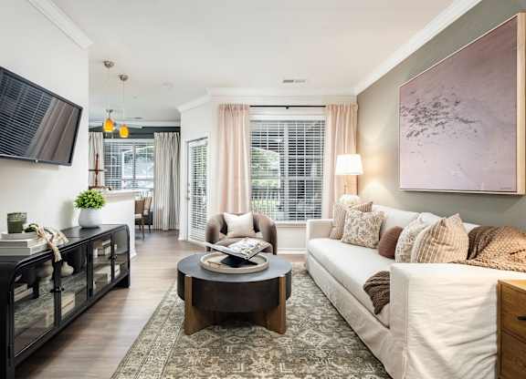 A living room with a white couch and a coffee table.