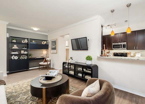 A modern living room with a brown chair and a black cabinet.