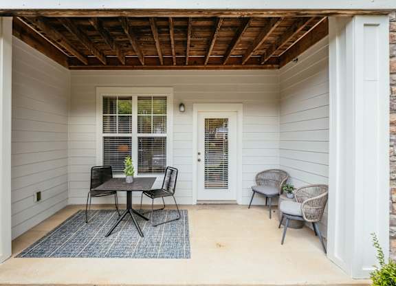 A patio with a table and chairs is shown.