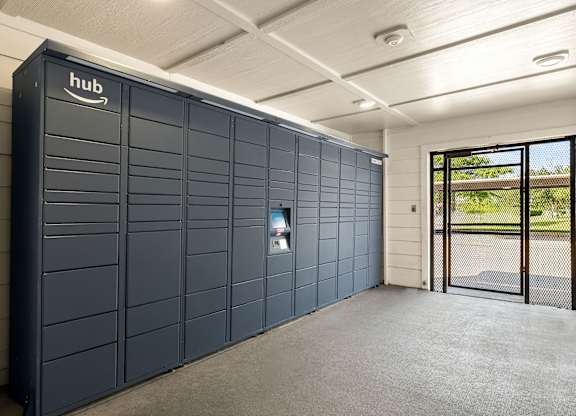 A large, dark-colored Amazon storage unit is situated in a spacious, well-lit room.