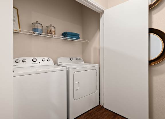 A white washing machine and dryer in a small laundry room.
