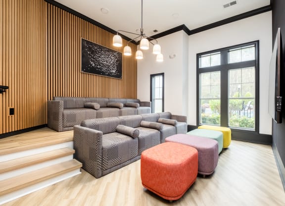 a living room with couches and chairs and a large window