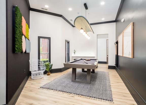 a game room with a shuffleboard table and a pool table