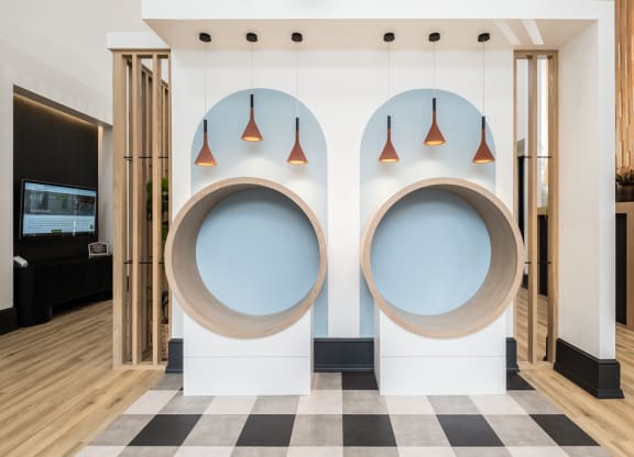 two circles on a wall with lamps and a checkered floor
