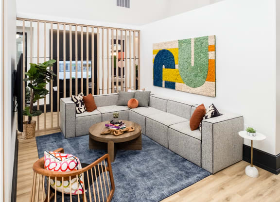 a living room with a couch and chairs and a rug