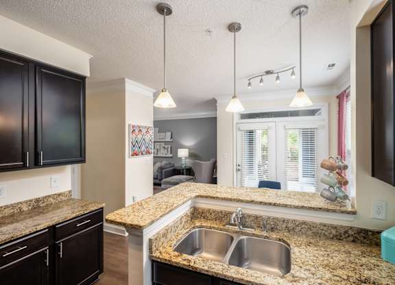 A kitchen with granite countertops and a sink.