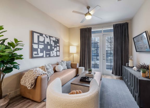 a living room with a couch and a ceiling fan