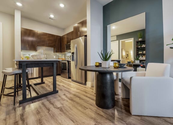 a living room with a kitchen and a dining table