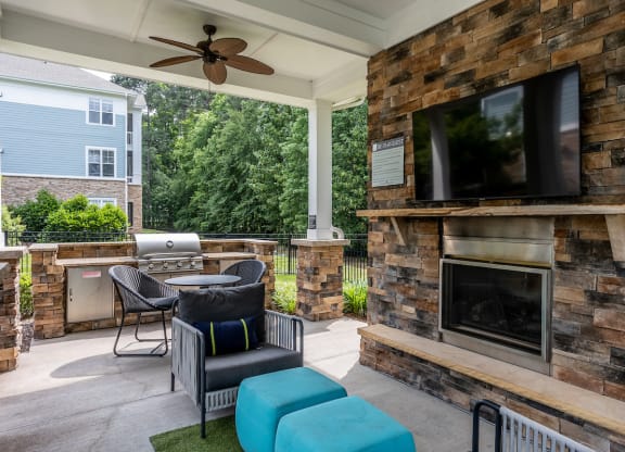 summerhouse with fireplace, seating, and tvs