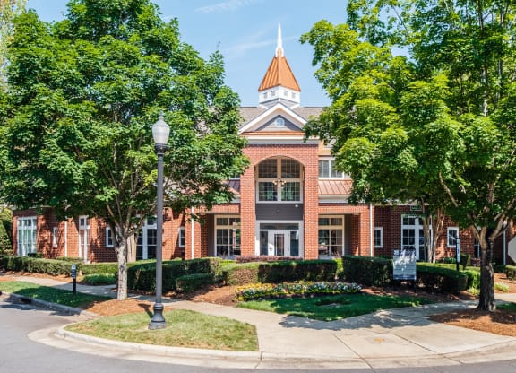 a large brick building with trees in front of it