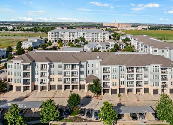 A large apartment complex with multiple buildings and parking lots.