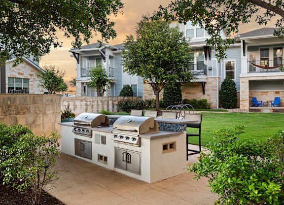 Outdoor kitchen with a grill and sink.