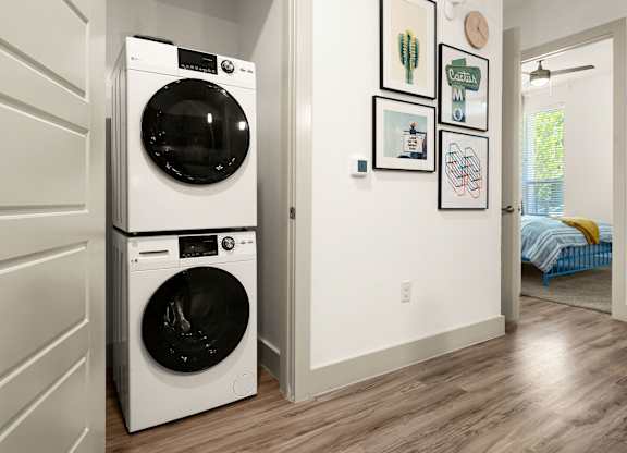 A white washer and dryer in a laundry room.
