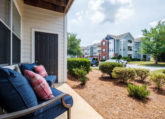 a couch on a porch in front of an apartment building