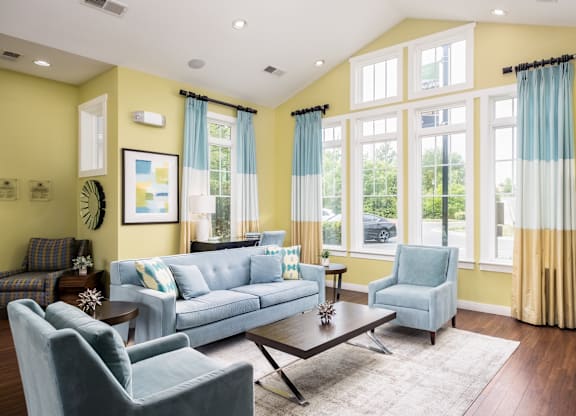 A living room with a blue couch and a coffee table.