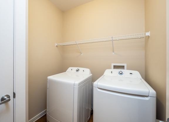 A small laundry room with a washer and dryer.