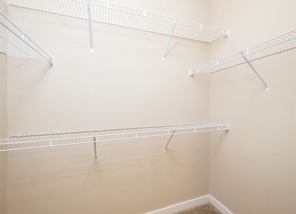 Empty white shelves in a room.