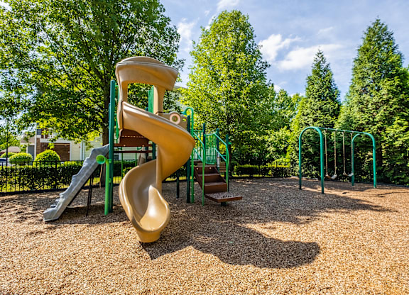 A playground with a slide and a climbing frame.