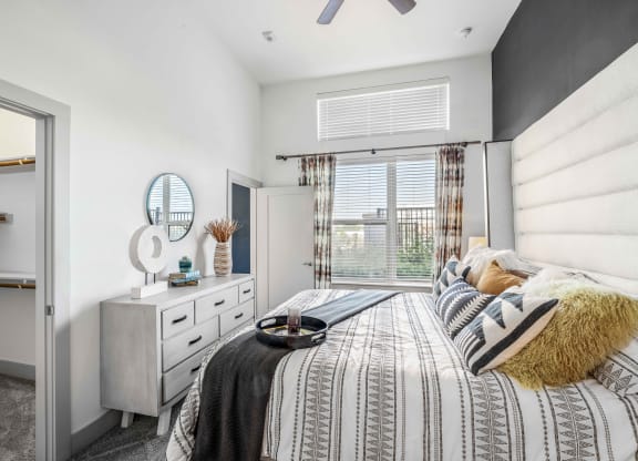 a bedroom with a bed and a window